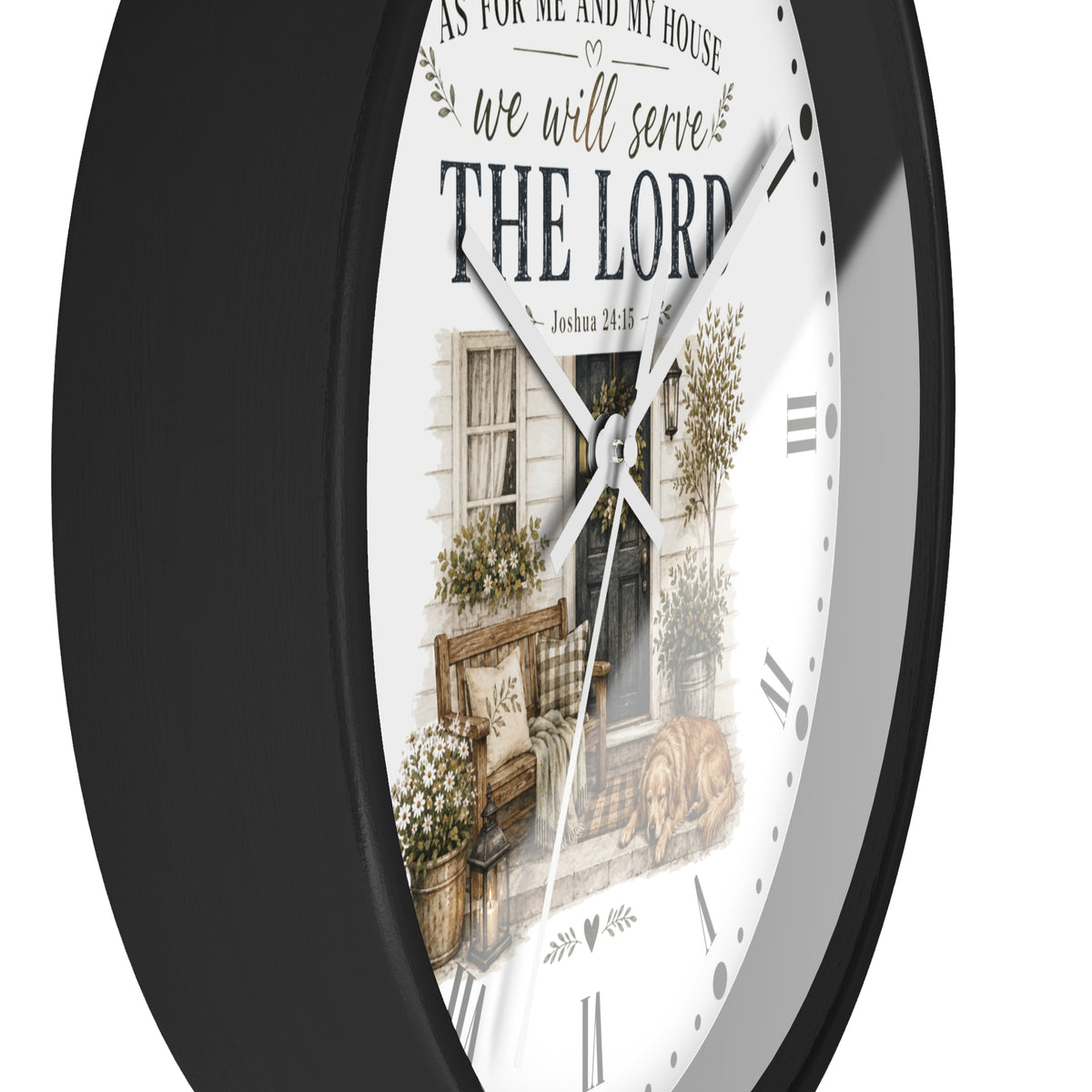 A round wall clock with a black frame and a white face featuring a rustic illustration of a house porch and the text 'we will serve THE LORD' and 'As for me and my house, so be it.'.
