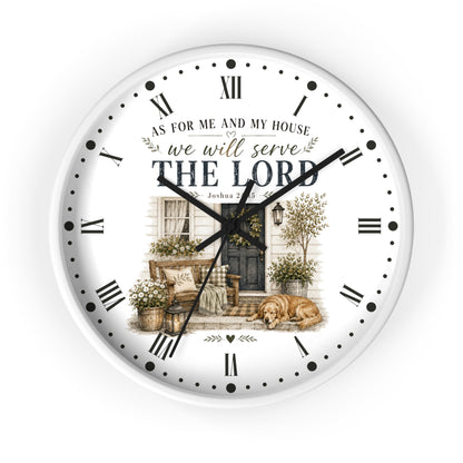 A round wall clock with a white face, black Roman numerals, black hands, and a printed illustration of a porch scene with the text 'AS FOR ME AND MY HOUSE we will serve THE LORD'.