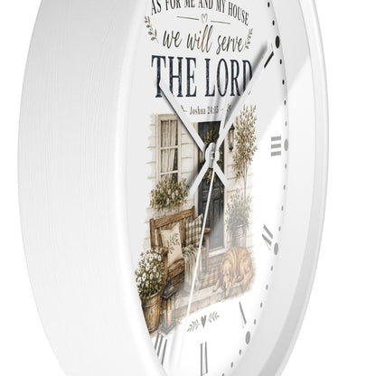 White round wall clock with a rustic printed illustration of a front porch and the text 'AS FOR ME AND MY HOUSE we will serve THE LORD' with Roman numerals and black hands.