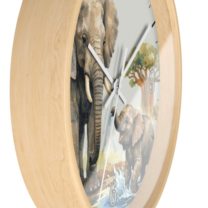 Round wall clock with a light natural wood frame and a printed elephant scene on the face, including a large elephant, a baby elephant, water, and trees. The clock is shown against a plain white background.