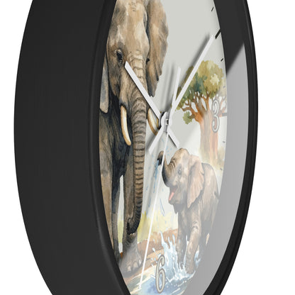 A round wall clock with a black frame and a printed elephant-themed dial showing a large gray elephant, a baby elephant, water, and a tree on a white background.