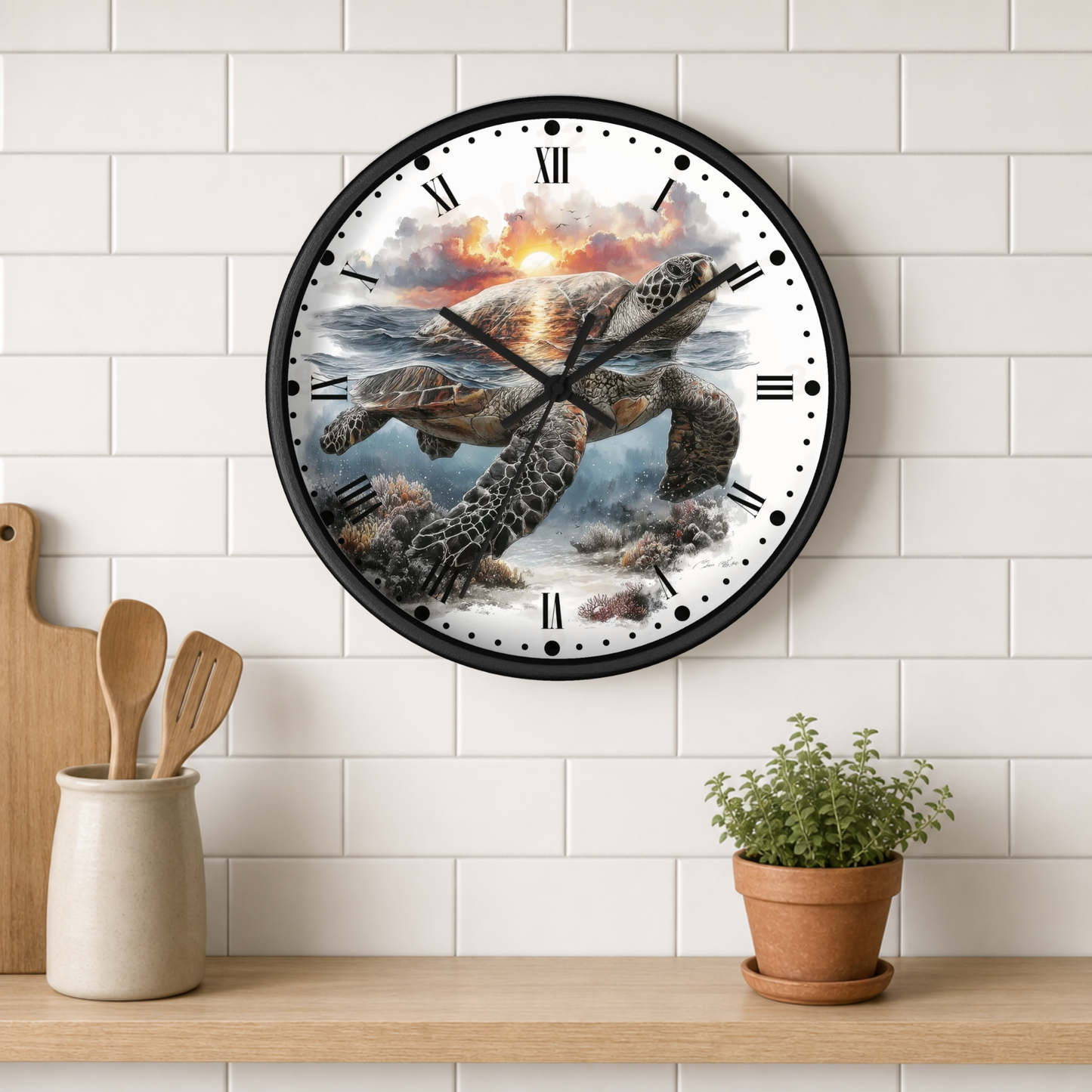 A round wall clock with a black frame and Roman numerals, featuring a printed illustration of a sea turtle swimming underwater at sunset, mounted on a white subway tile wall above a wooden shelf with kitchen utensils and a potted plant.