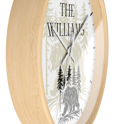 Personalized oval wall clock with a light natural wood frame and a white face featuring a forest illustration with a horse and bear, and the name 'THE WILLIAMS' in black text.