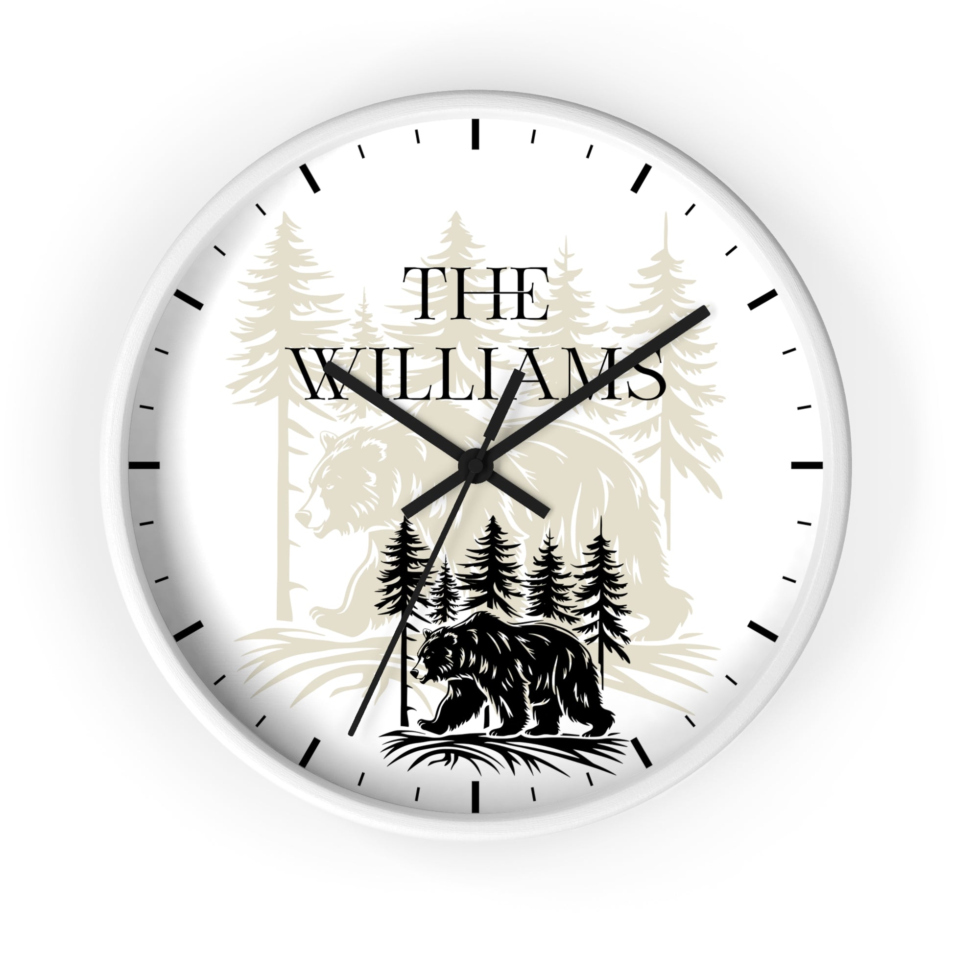 A round custom wall clock with a white face, black hands, and black hour markers. The dial features a personalized design with the text 'THE WILLIAMS' over a forest illustration, including a bear at the bottom.