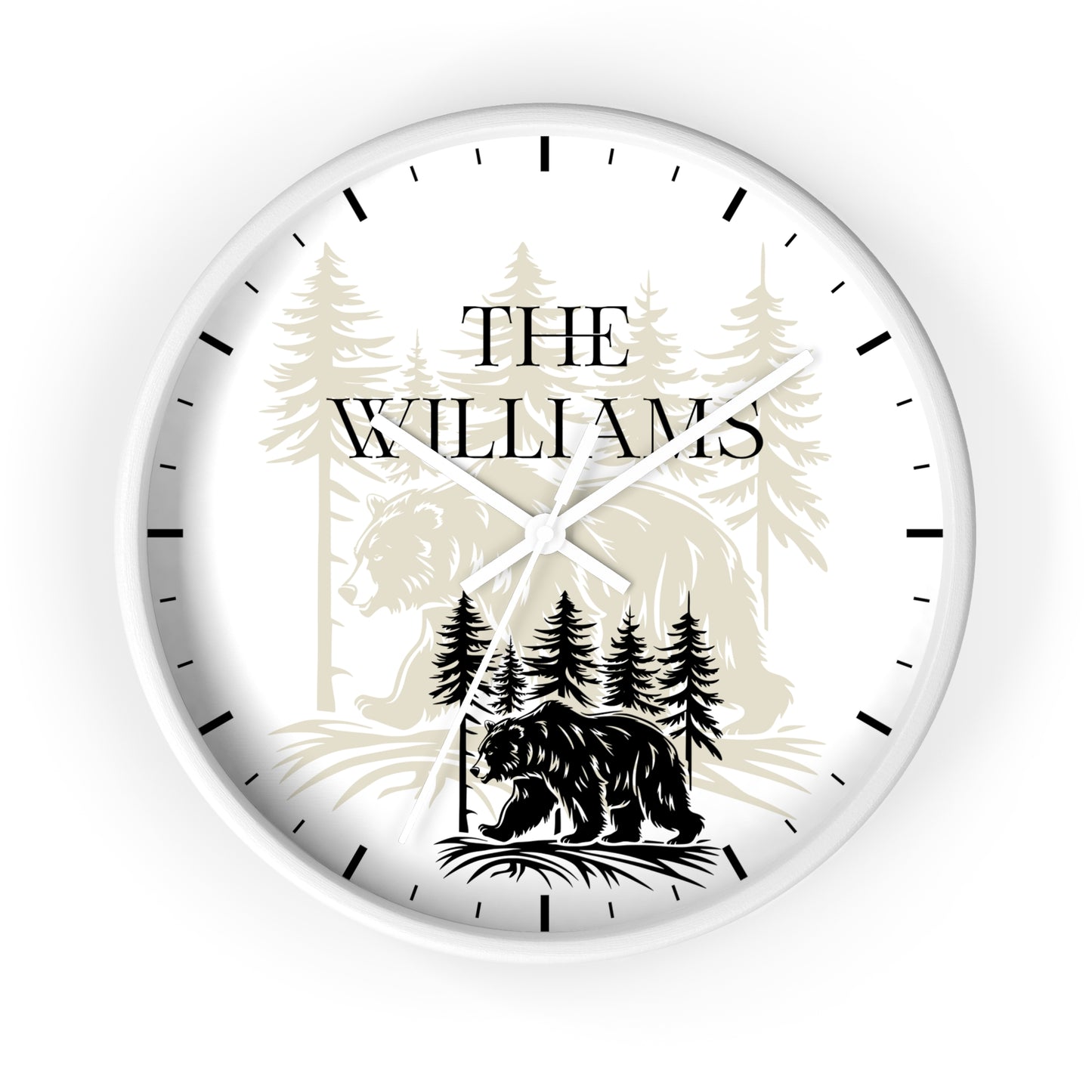 A personalized round wall clock with a white face, black hands, and black hour markers. The center features a custom graphic with the text 'THE WILLIAMS' above a black bear silhouette and pine tree forest illustration.