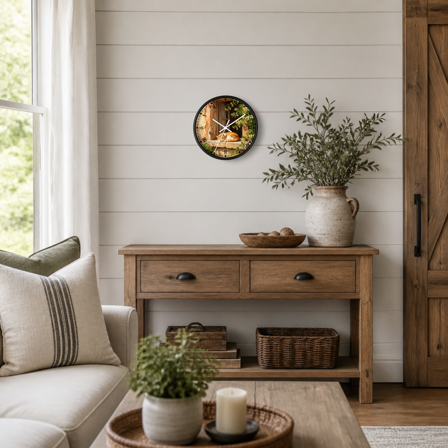 A round wall clock with a colorful nature print and white clock hands, hanging on a white shiplap wall above a rustic wooden console table in a bright, modern farmhouse living room.
