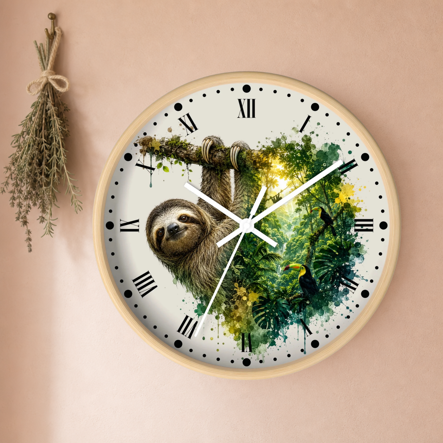 A round wall clock with a light wood frame hangs on a warm beige wall. The clock face features a sloth hanging from a tree branch over a vibrant green jungle watercolor design, with black Roman numerals and white hands.