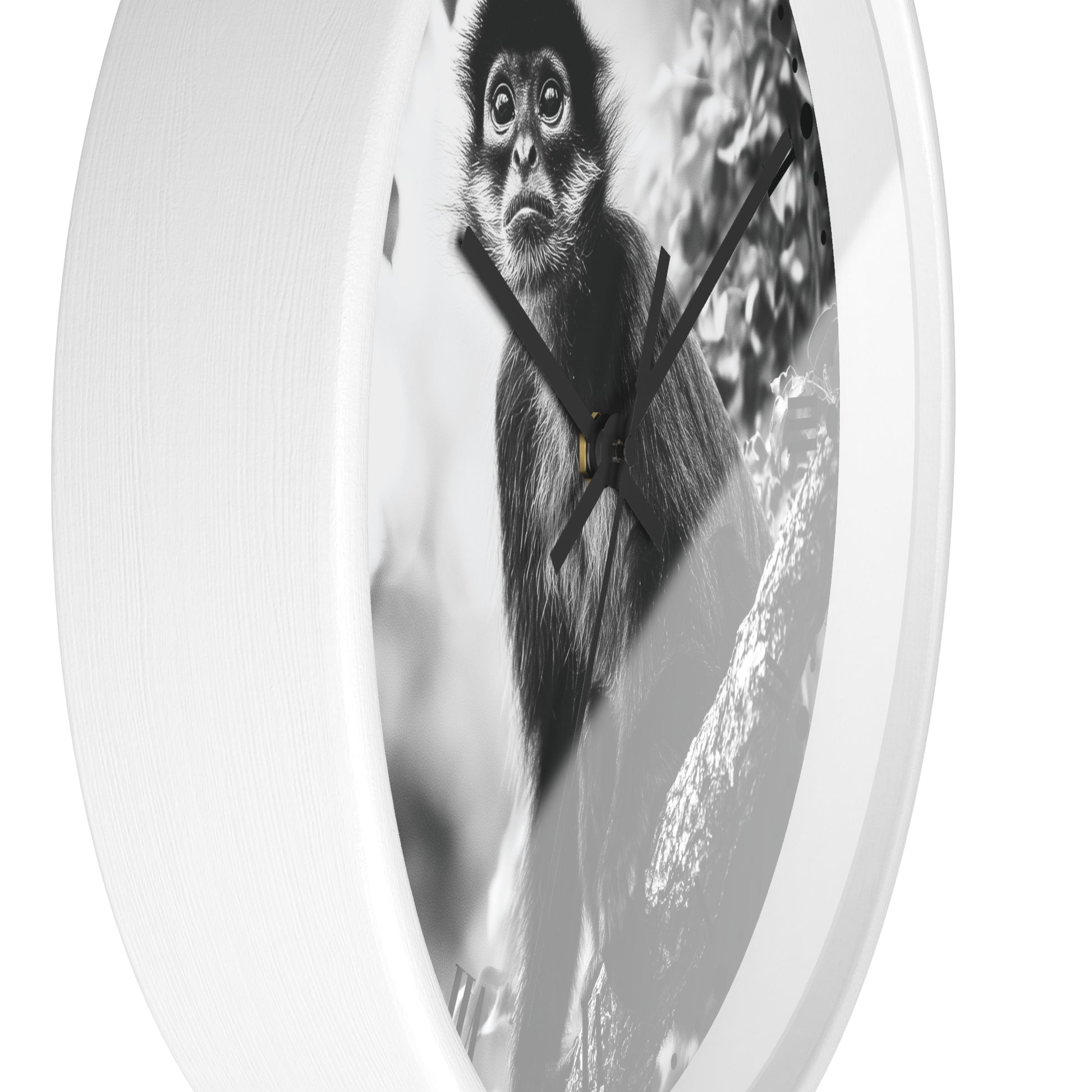 Round wall clock with a white frame and a black-and-white photographic print of a monkey on the face, shown against a plain white background.