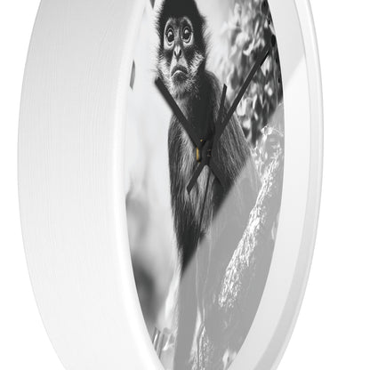 Round wall clock with a white frame and a black-and-white photographic print of a monkey on the face, shown against a plain white background.