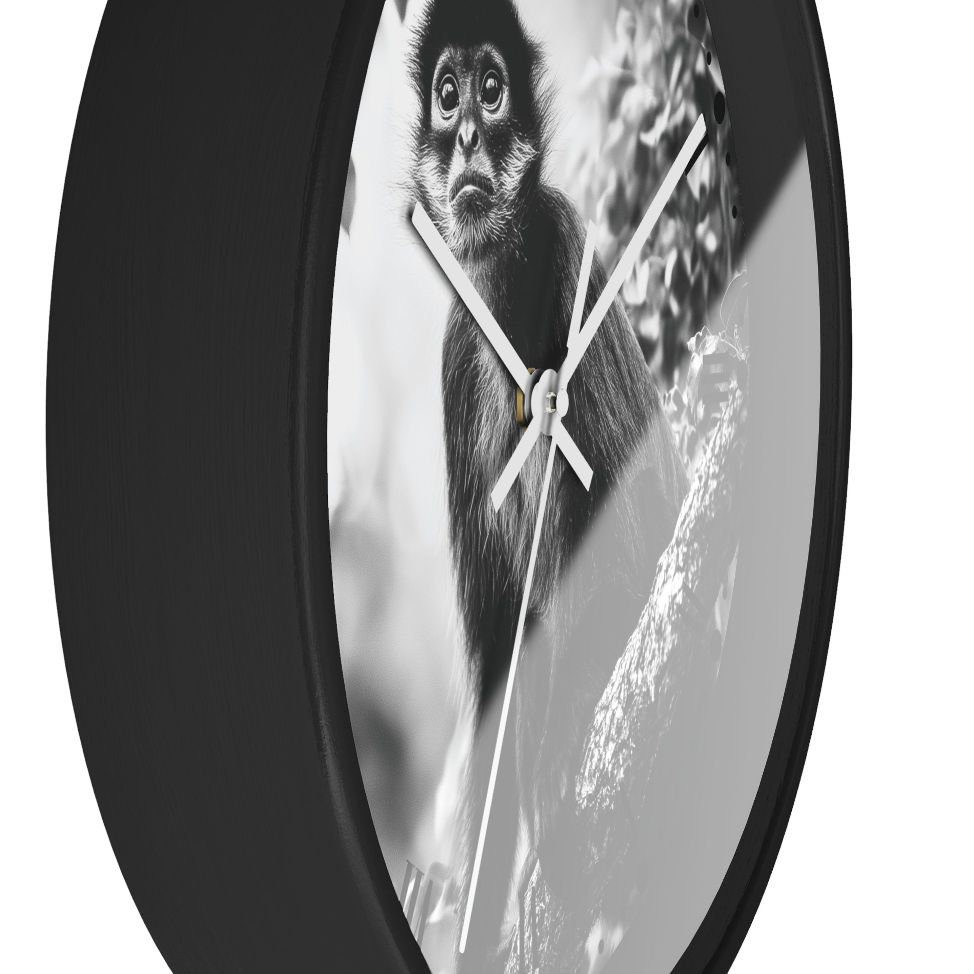A round wall clock with a black frame and white hands, featuring a black-and-white photograph of a monkey on the faceplate, shown against a plain white background.