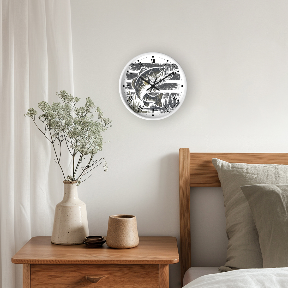 A round wall clock with a black and white fish illustration hangs on a light beige wall above a wooden nightstand in a styled bedroom setting.