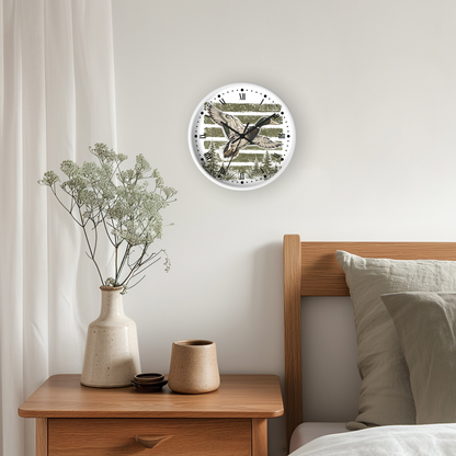 A round wall clock with a mallard duck illustration and striped background, mounted on a light gray wall above a wooden nightstand with a vase and pillows.