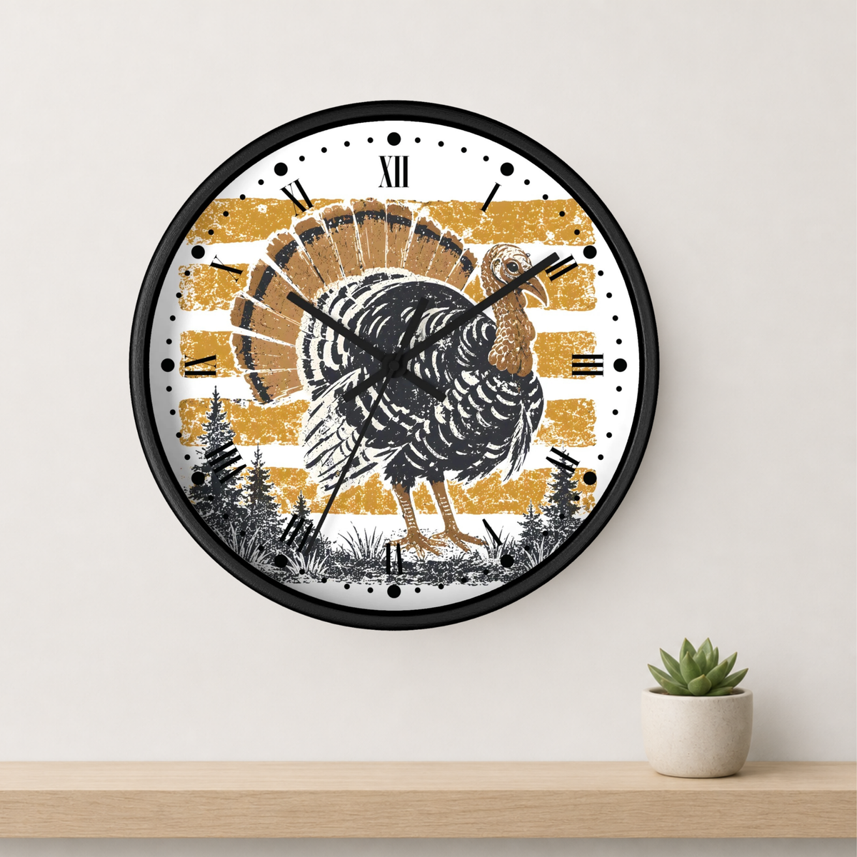 A round wall clock with a black frame and a rustic Thanksgiving turkey design, mounted on a light beige wall above a wooden shelf with a small potted succulent.