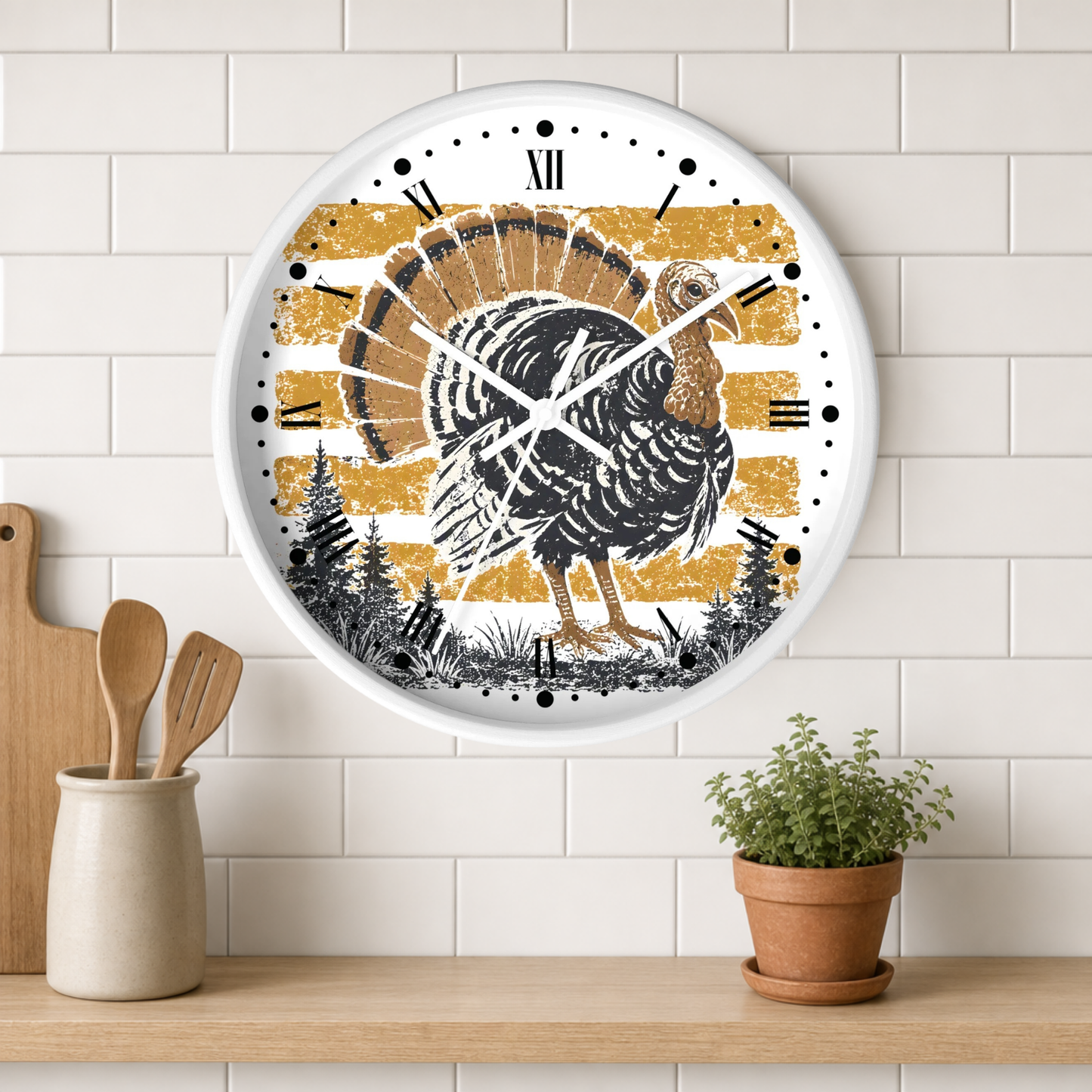 A round wall clock with a white frame and a rustic Thanksgiving turkey design, mounted on a white subway tile wall above a wooden shelf with kitchen utensils and a potted plant.