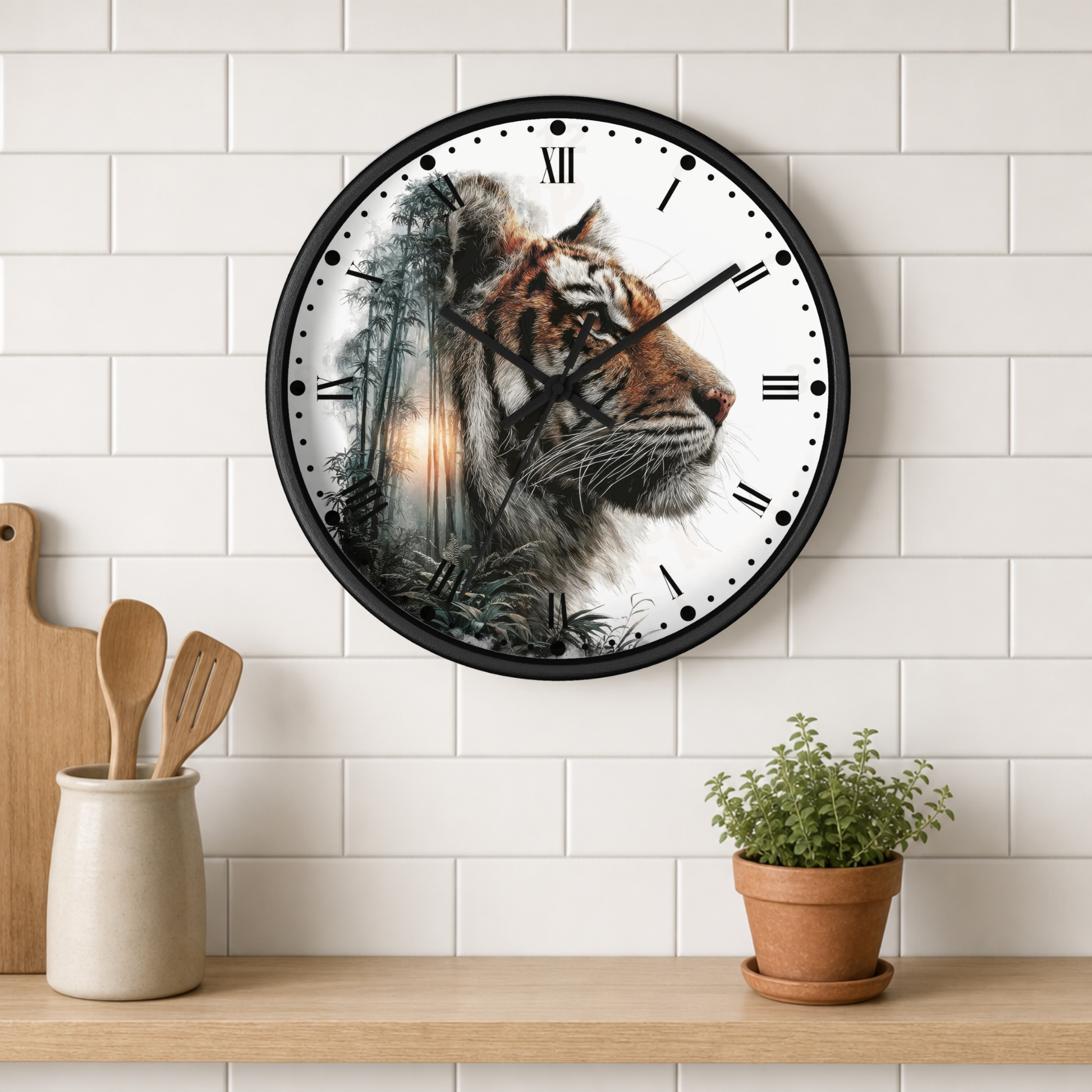 A round wall clock with a black frame and a white face featuring a detailed tiger illustration, hanging on a white subway tile wall above a wooden shelf with kitchen utensils and a potted plant.