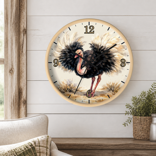 A round wall clock with a light wood frame and a vintage-style ostrich illustration on the face, mounted on a white shiplap wall above a wooden mantel with a small potted plant.
