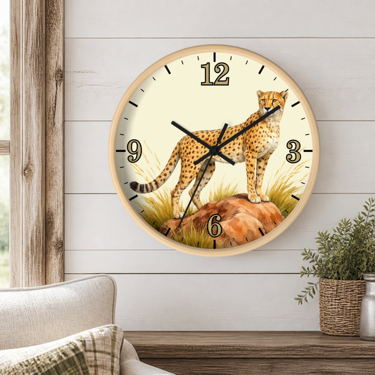 A round wall clock with a cheetah illustration on the face, mounted on a white shiplap wall above a wooden mantel with a small potted plant.