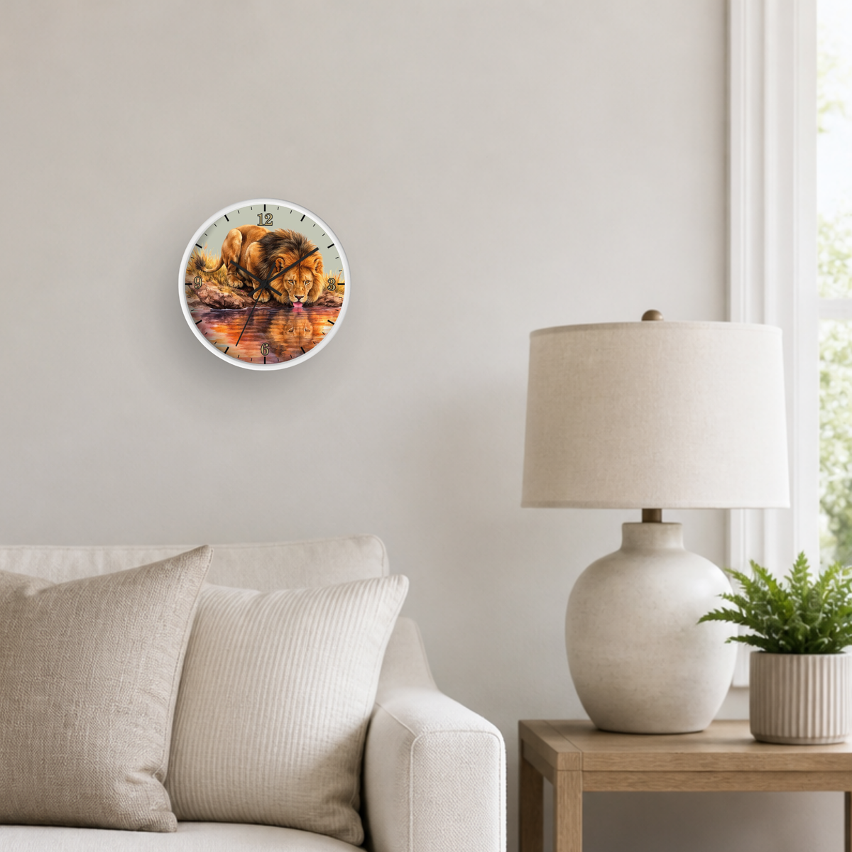 A round wall clock with a colorful autumn leaf design, mounted on a light beige wall in a modern living room setting next to a lamp and sofa.