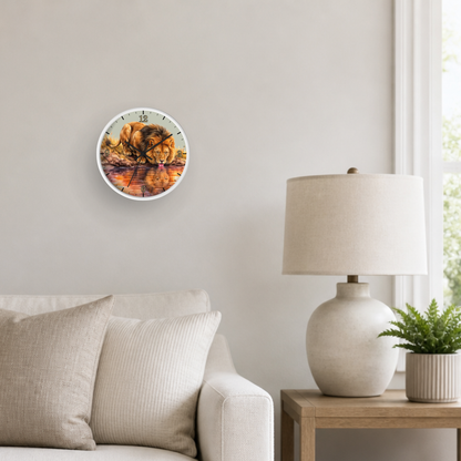 A round wall clock with a colorful autumn leaf design, mounted on a light beige wall in a modern living room setting next to a lamp and sofa.