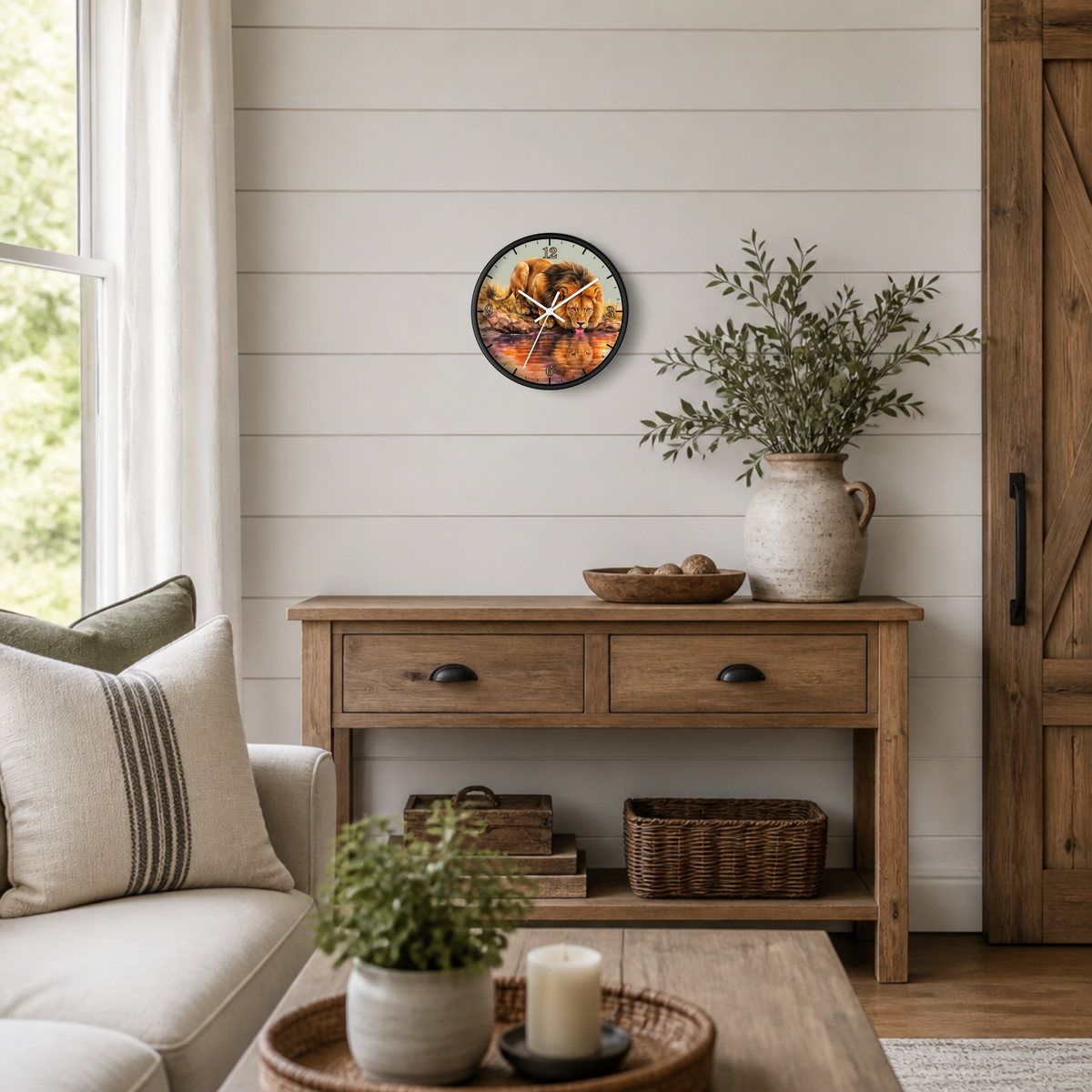A round wall clock with a rustic jungle big cat print hangs on a white shiplap wall above a wooden console table in a styled living room setting.