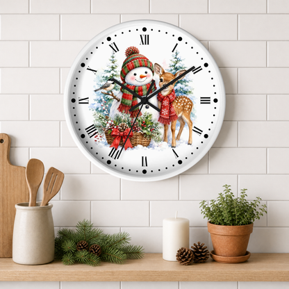 A round wall clock with a festive winter illustration of a snowman and deer, mounted on a white subway tile wall above a wooden shelf with kitchen decor.