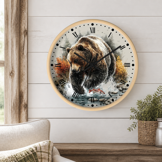 Round wall clock with a natural wood frame and a printed design of a brown bear fishing, mounted on a white wood-paneled wall above a wooden shelf with a plant.