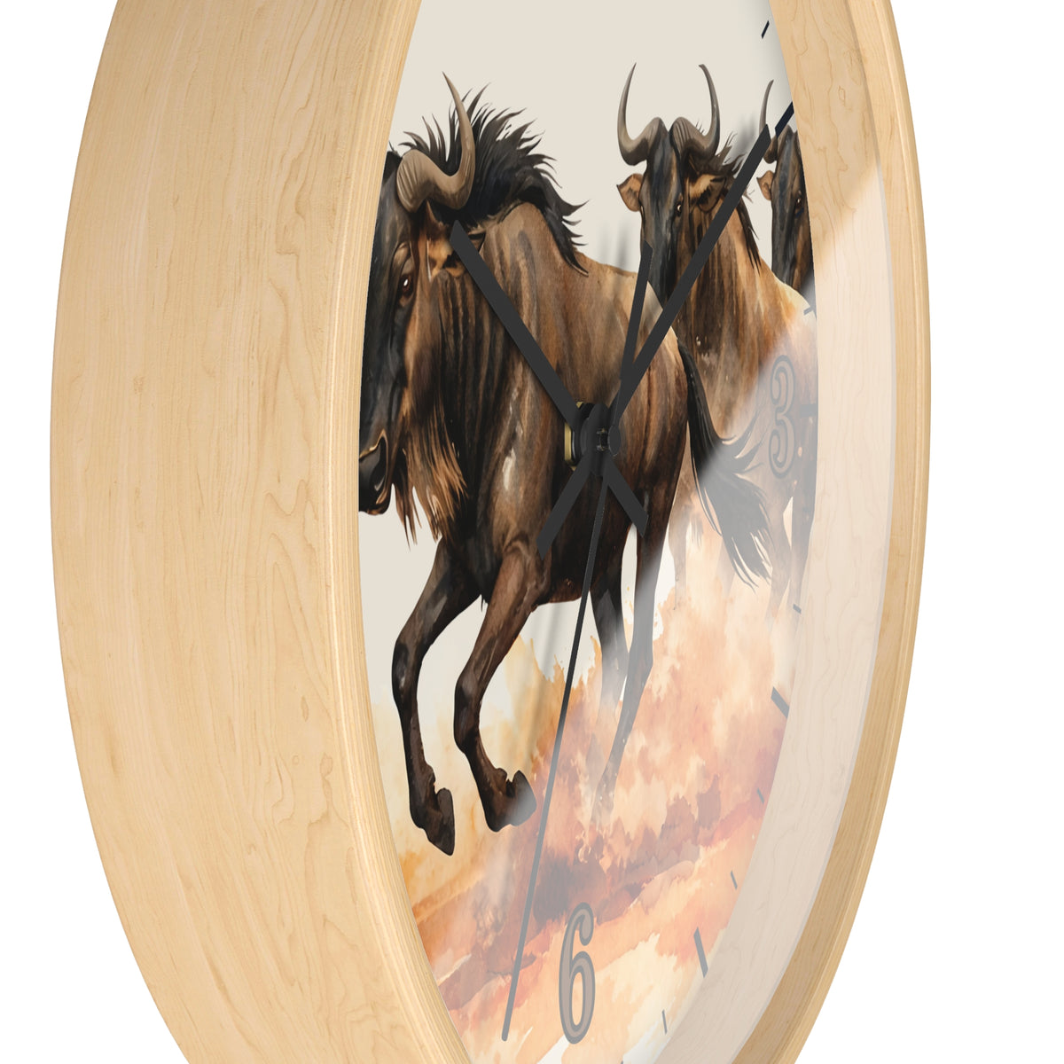 Round wall clock with a light natural wood frame and a printed face showing two brown wildebeest against a warm cream and orange sky. Black clock hands and small black numeral markers are visible.