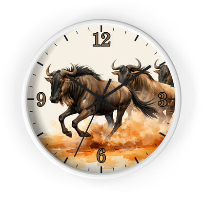 Round wall clock with a white frame and a printed illustration of three bison running across an orange and brown landscape. The clock face is cream-colored with black numerals and black clock hands.