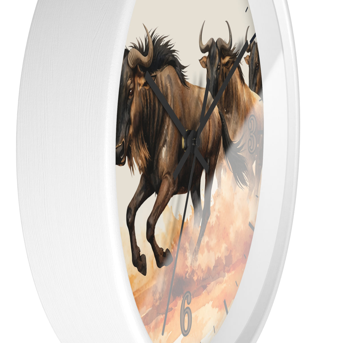 Round wall clock with a white frame and a printed design of two brown wildebeest running across a warm-toned desert landscape, shown against a white background.