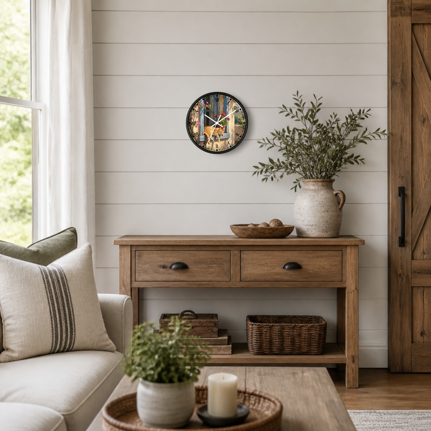 A round wall clock with a colorful nature print and white clock hands, hanging on a white shiplap wall above a rustic wooden console table in a bright, modern farmhouse living room.
