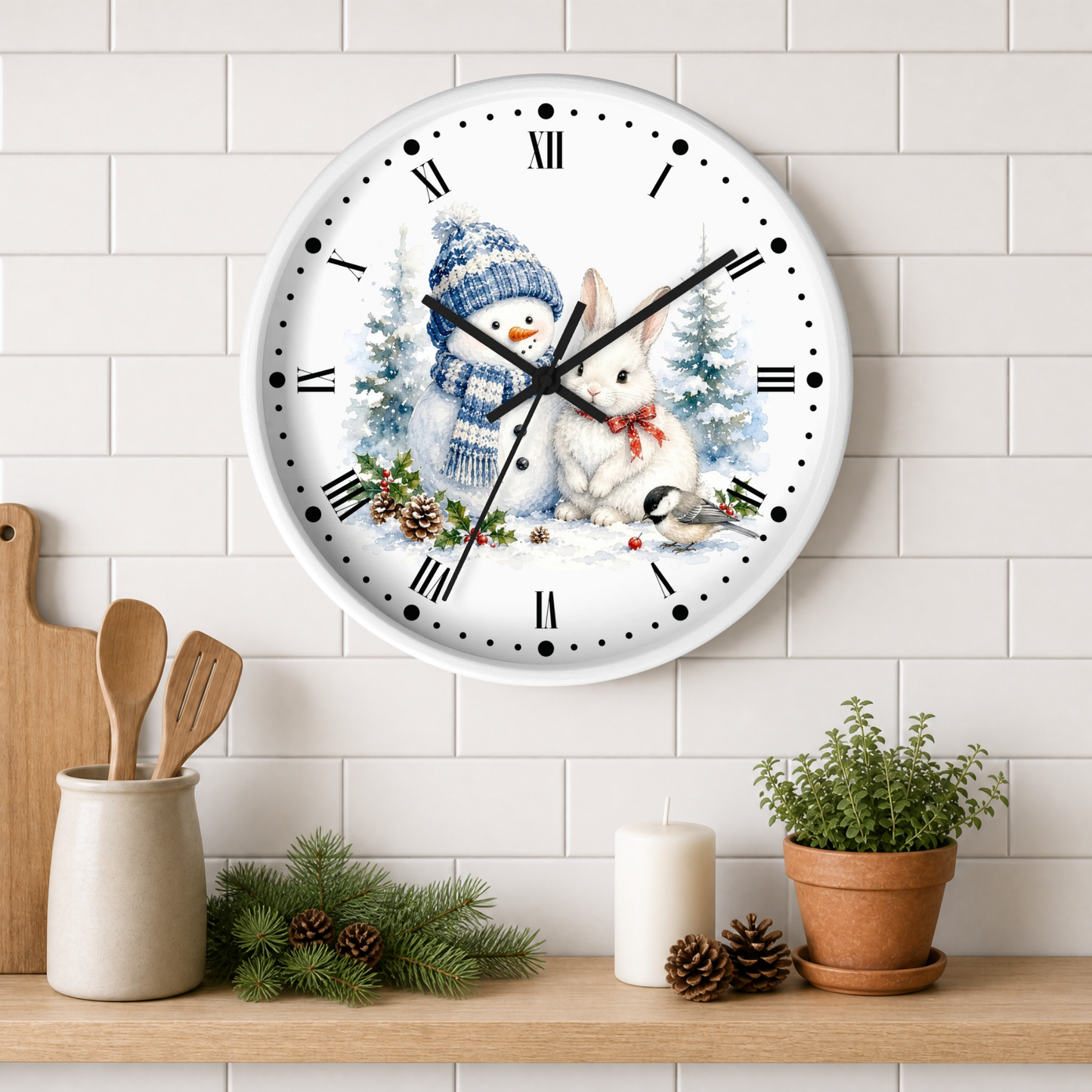 A round wall clock with a winter holiday illustration of a snowman and rabbit, mounted on a white subway tile wall above a wooden shelf with kitchen props.