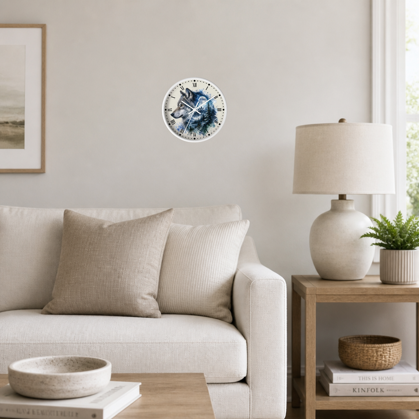 A circular wall clock featuring a wolf illustration, mounted on a light beige wall in a modern living room setting with a sofa, side table, and lamp.