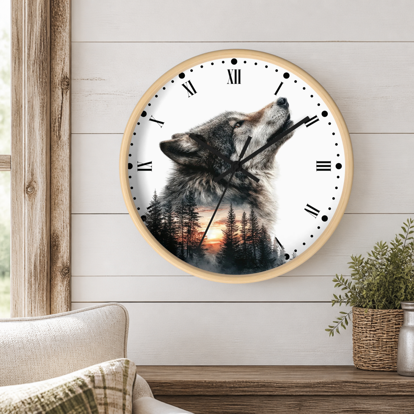 A round wall clock with a light wood frame hangs on a white shiplap wall above a wooden mantel. The clock face features a wolf howling over a pine forest at sunset, with black Roman numerals and hands.